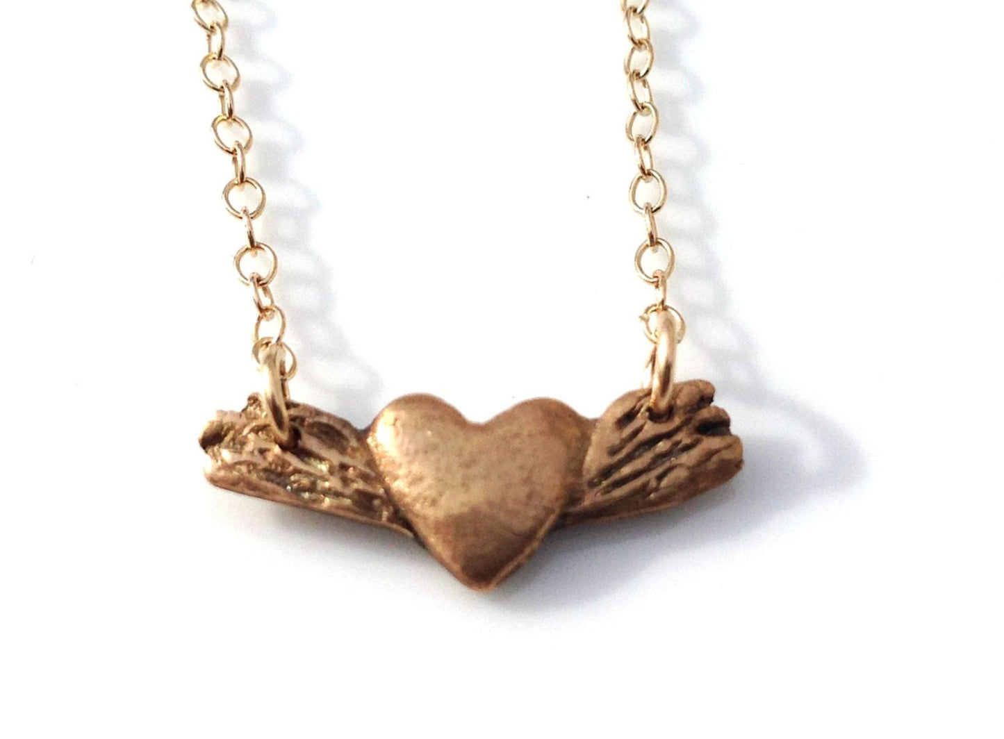 Tiny bronze winged heart