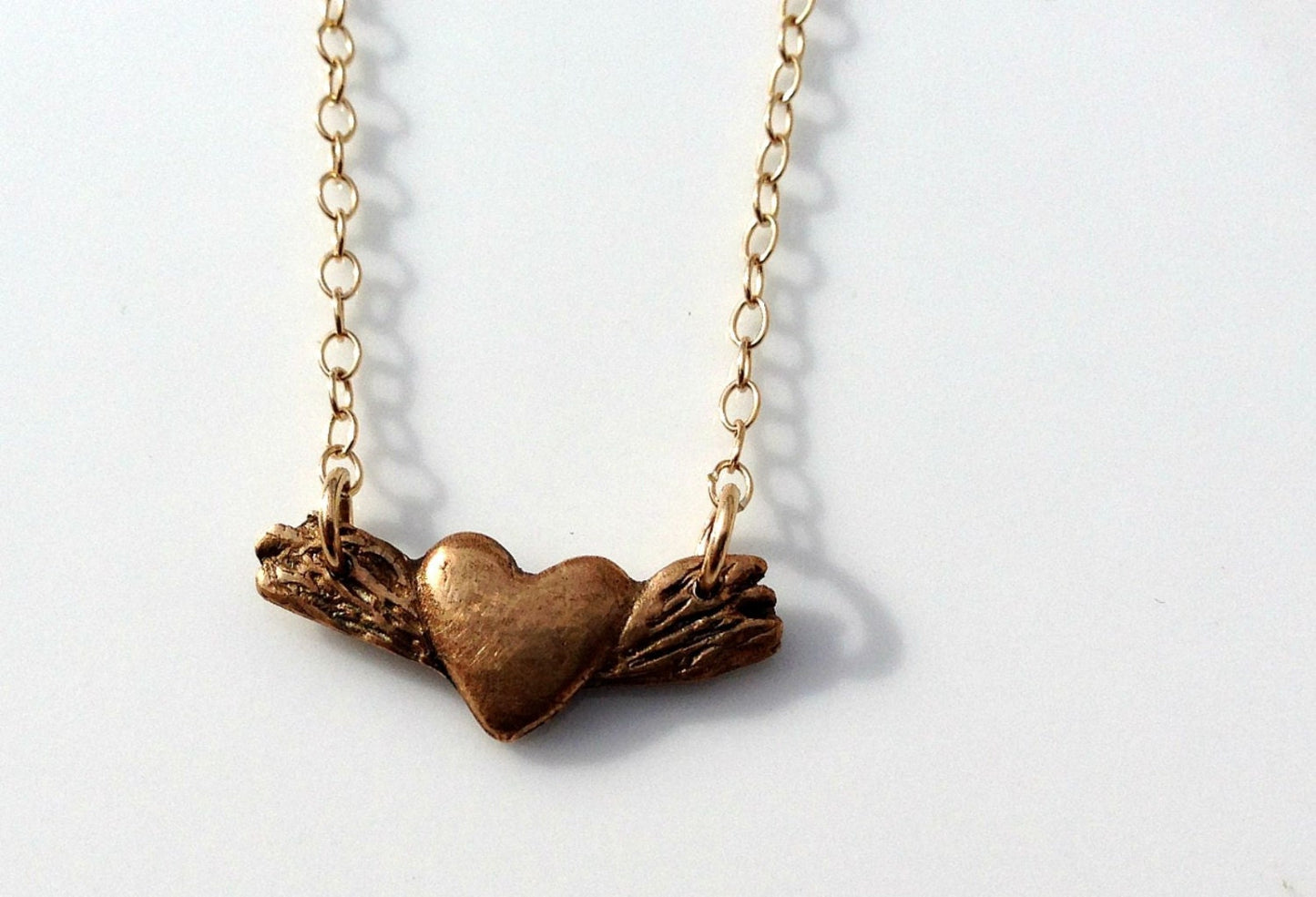 Tiny bronze winged heart